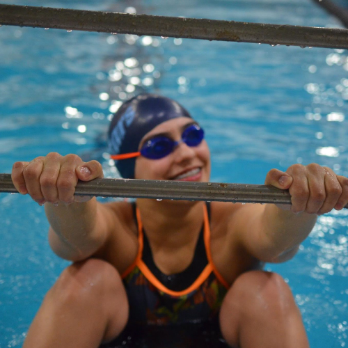  An image of Madison holding on to a rail in the pool.