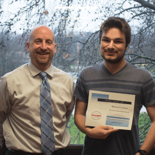  An image of principal Dr. Croley and Michael holding his certificate.